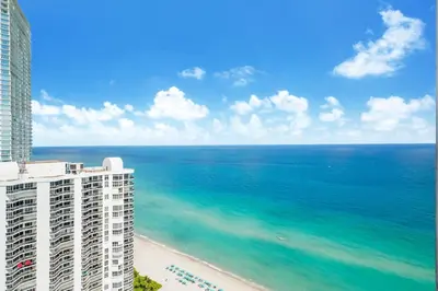 a view of the ocean from the balcony of a building at A Breathtaking Oceanview - High Rise Luxury Condo in Sunny Isles Beach