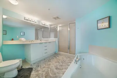 a bathroom with a tub and a toilet and a sink at Balcony on the Ocean - Picture Perfect in Sunny Isles Beach