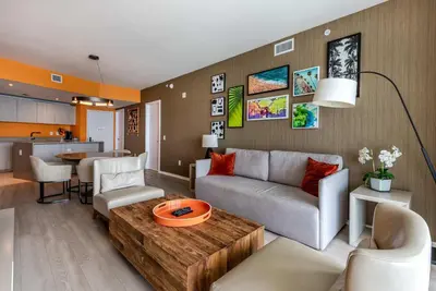 a living room with a couch and a table at Luxury Living on the Beach with Resort Amenities in Hollywood