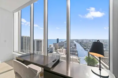 an office with a desk and chairs and a large window at 2BR Ocean Penthouse - Private Terrace & Hot Tub in Hollywood
