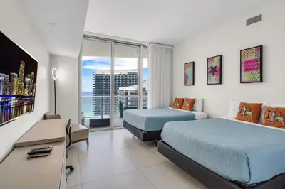 a hotel room with two beds and a television at Luxury Penthouse 4 BDR with Resort Amenities in Hollywood