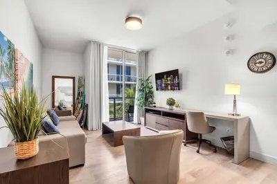 a living room with a couch and a desk at Condo with 1 Bedroom Terrace and Hot Tub in Hollywood