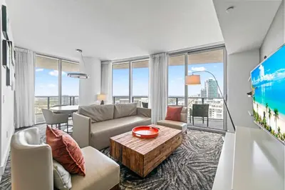 a living room with a couch and a table at Sunny Balcony - Beautiful Stay for 2 with Ocean Views & Resort Amenities in Hollywood