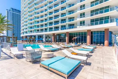 a pool with lounge chairs and a building at Sunny Balcony - Beautiful Stay for 2 with Ocean Views & Resort Amenities in Hollywood