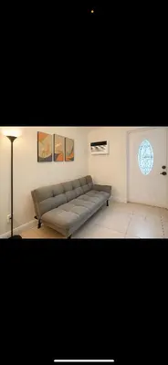 a living room with a couch and a window at La sama Wynwood in Miami