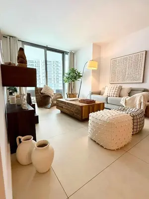 a living room with a couch and a table at Cosy 1 Bedroom Breathtaking Ocean Views at LYFE Resort in Hollywood