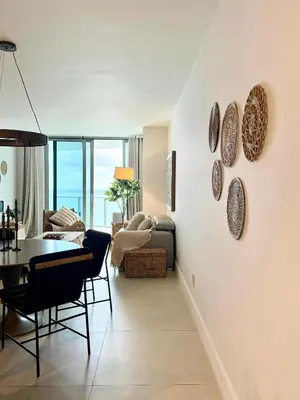 a living room with a table and a dining room at Cosy 1 Bedroom Breathtaking Ocean Views at LYFE Resort in Hollywood