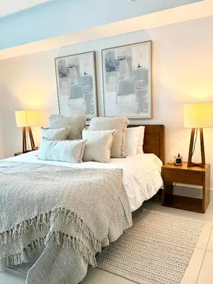 a bedroom with a bed and two pictures on the wall at Cosy 1 Bedroom Breathtaking Ocean Views at LYFE Resort in Hollywood