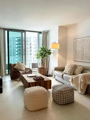 a living room with a couch and a table at Cosy 1 Bedroom Breathtaking Ocean Views at LYFE Resort in Hollywood