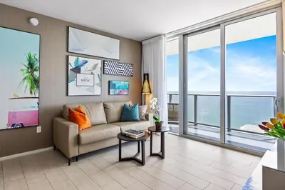 a living room with a couch and large windows at 5-BR Retreat Resort & Valet Included 14 Guests in Hollywood