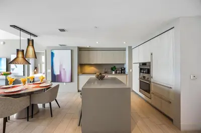 a kitchen and dining room with a table and a dining room at 5-BR Retreat Resort & Valet Included 14 Guests in Hollywood