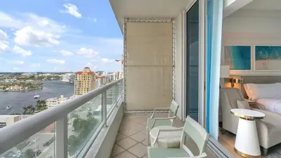 a balcony with a bed and a view of the water at Ritz-Carlton 2br 17th fl Penthouse Hotel Condo in Fort Lauderdale