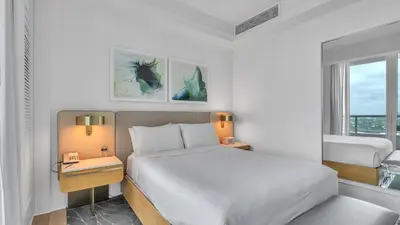 a white bedroom with a bed and a window at Ritz-Carlton 2br 17th fl Penthouse Hotel Condo in Fort Lauderdale