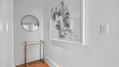 a hallway with a mirror and a white wall at Ritz-Carlton 2br 17th fl Penthouse Hotel Condo in Fort Lauderdale