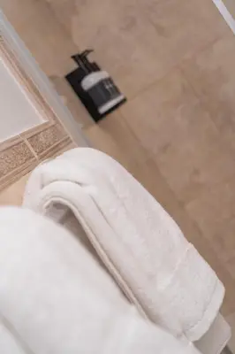 a white towel sitting on top of a bed in a bathroom at Instant Stay Ocean Drive in Miami Beach