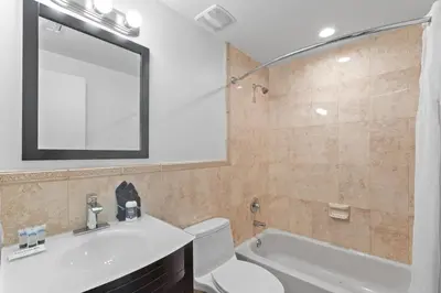 a bathroom with a sink toilet and a mirror at Instant Stay Ocean Drive in Miami Beach