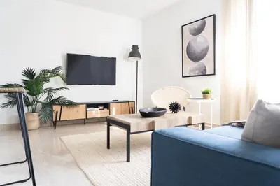 a living room with a blue couch and a tv at Instant Stay Ocean Drive in Miami Beach