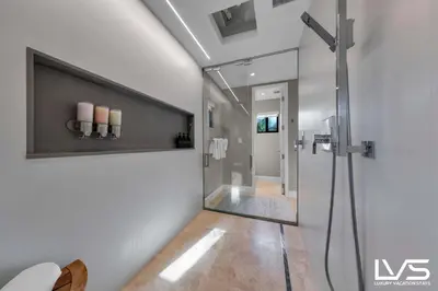 a bathroom with a shower with a glass door at Villa Marea - Heated Pool Spa & Water Views in Fort Lauderdale