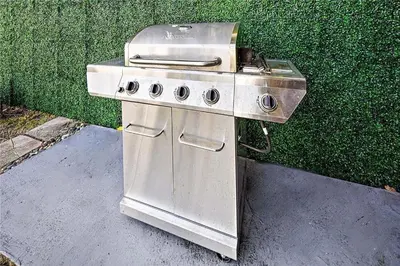 a stainless steel barbecue grill sitting on a sidewalk at Bayside Bliss on Marseille in Miami Beach