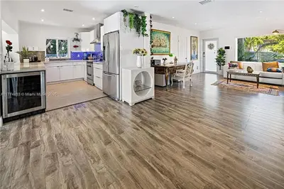 a large kitchen and living room with a refrigerator at Bayside Bliss on Marseille in Miami Beach