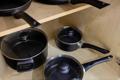two pots and pans sitting on a stove at Walk To Coral Gables | SLEEP 8| Free BEACH Package in Miami
