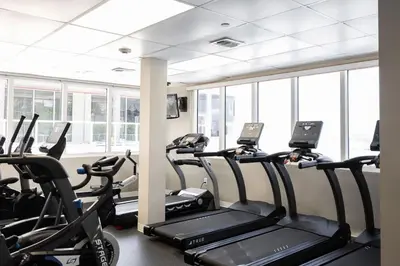 a gym with several tread machines in a room with windows at Beachfront Studio - Marco Polo Sunny Isles -2Beds in Sunny Isles Beach