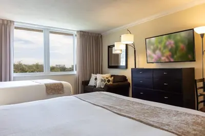 a hotel room with a bed and a television at Beachfront Studio - Marco Polo Sunny Isles -2Beds in Sunny Isles Beach