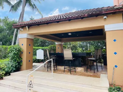 a patio with a table and chairs under a pavilion at Apartment 2 Bedrooms at Yacht Club of Aventura in Miami