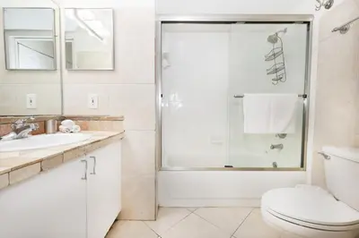 a bathroom with a shower and a toilet and a sink at Apartment 2 Bedrooms at Yacht Club of Aventura in Miami