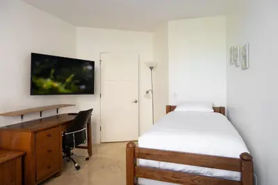 a bedroom with a desk and a bed and a desk and chair at Luxe 3BR Apartment with Great Patio at Yacht Club in Aventura