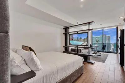 a bedroom with a bed and a desk with a large window at 2304 Luxury Miami Studio Stunning Bay View in Miami