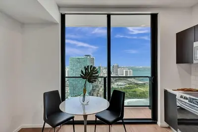a kitchen with a table and chairs and a window at 2304 Luxury Miami Studio Stunning Bay View in Miami