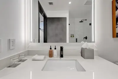 a white bathroom with a sink and a mirror at 2304 Luxury Miami Studio Stunning Bay View in Miami