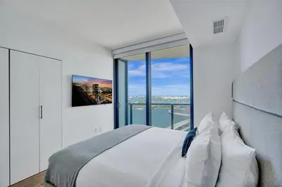 a bedroom with a bed and a large window at Miami Lux 1BR 37th Floor Bay City Views in Miami