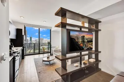 a living room with a flat screen tv on a wall at 4704 Lux Miami Studio City Bay Views in Miami
