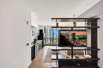 a living room with a flat screen tv on a wall at 4704 Lux Miami Studio City Bay Views in Miami