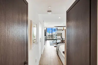 a hallway with a bed and a table in a room at 4704 Lux Miami Studio City Bay Views in Miami