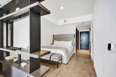 a bedroom with a large white bed and a desk at 4604 Lux Miami Studio City and Bay Views in Miami