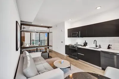 a living room with a couch and a kitchen at 4604 Lux Miami Studio City and Bay Views in Miami