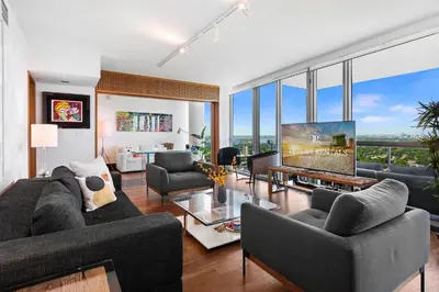 a living room with two couches and a tv at Oceanview Private Penthouse at The Setai - 3803 in Miami Beach