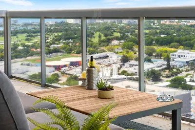 a table with a bottle of wine on top of a balcony at Oceanview Private Penthouse at The Setai - 3803 in Miami Beach