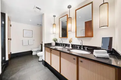 a bathroom with two sinks and a toilet at Oceanview Private Penthouse at The Setai - 3803 in Miami Beach