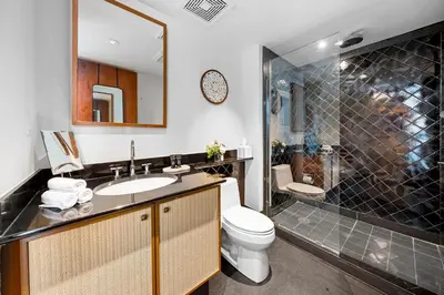 a bathroom with a sink and a toilet and a shower at Oceanview Private Penthouse at The Setai - 3803 in Miami Beach