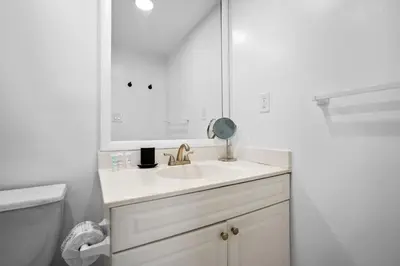 a white bathroom with a sink and a mirror at Condo w/2 Queen beds & Ocean View | Tides in Hollywood