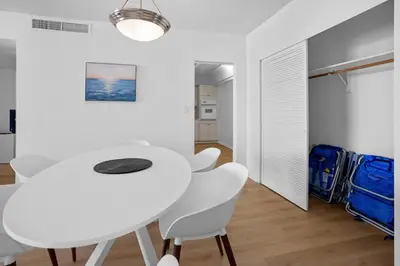a white dining room with a white table and chairs at Condo w/2 Queen beds & Ocean View | Tides in Hollywood