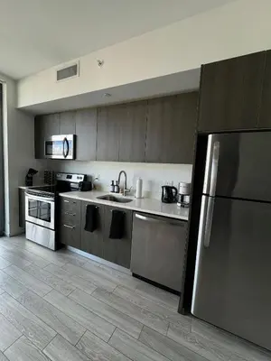 a kitchen with a sink and a refrigerator at Comfortable apartment in Downtown Miami in Miami