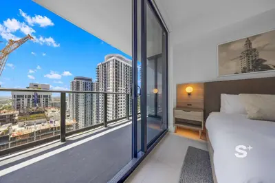 a bedroom with a bed and a view of a city at Modern 1-BD Condo in Downtown Miami City Views in Miami