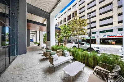 a patio with a white couch and chairs on a building at Modern 1-BD Condo in Downtown Miami City Views in Miami