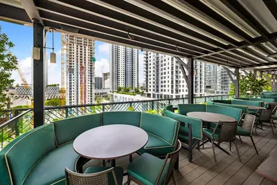 a balcony with tables and chairs and a view of a city at Modern 1-BD Condo in Downtown Miami City Views in Miami