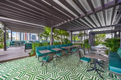 a restaurant with tables and chairs on a patio at Modern 1-BD Condo in Downtown Miami City Views in Miami